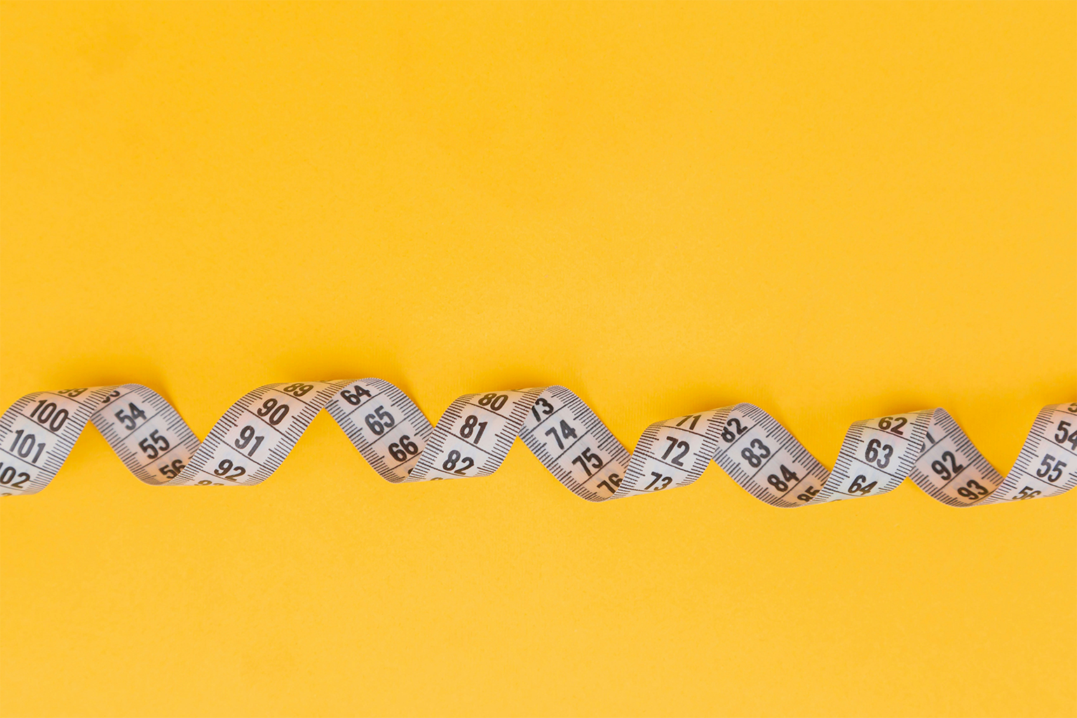 measuring tape with an orange background